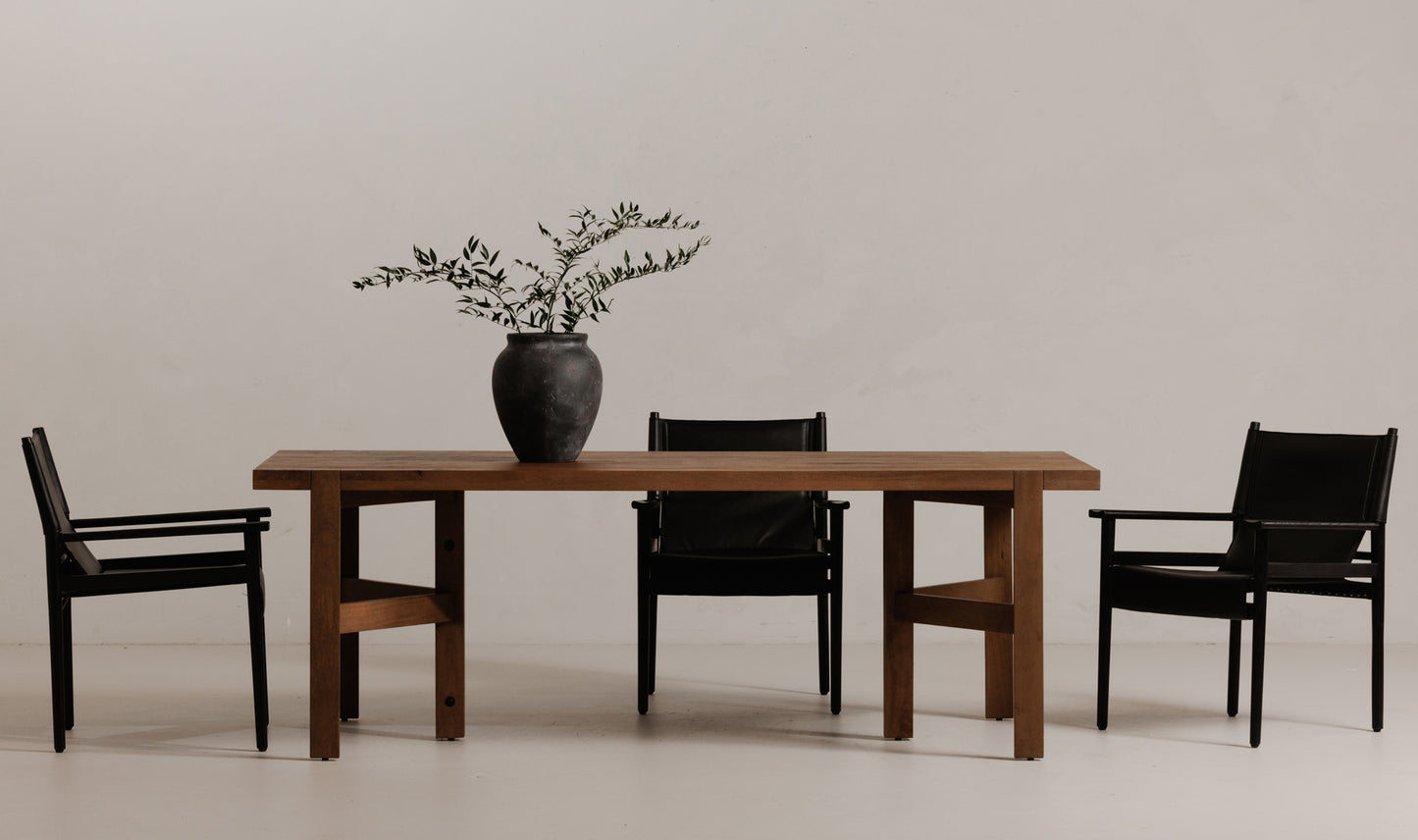 The Workshop Modern Wooden Dining Table with six chairs, demonstrating its capacity and modern look.