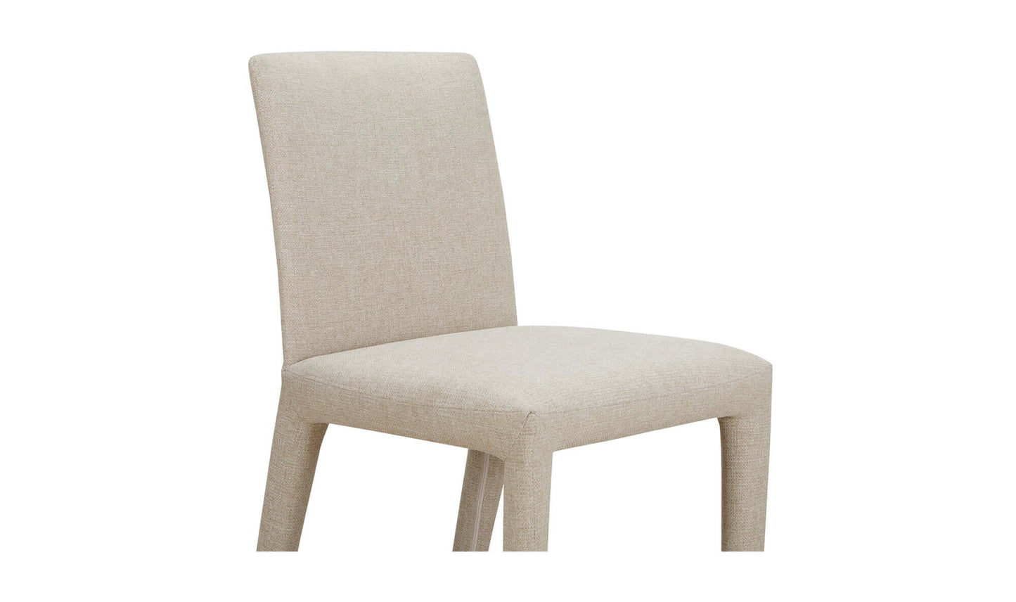 Side angle of the Monte Dining Chair in beige, highlighting the soft, stain-resistant fabric and cushioned seat.
