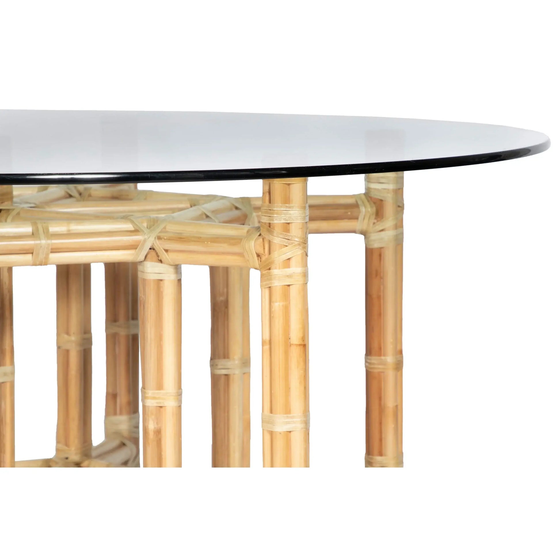 Close-up of a contemporary hexagonal rattan dining table base with glass top by David Francis.