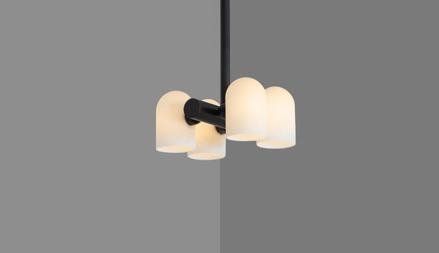 Odyssey 4 Pendant Light with lights glowing warmly in black gunmetal finish.