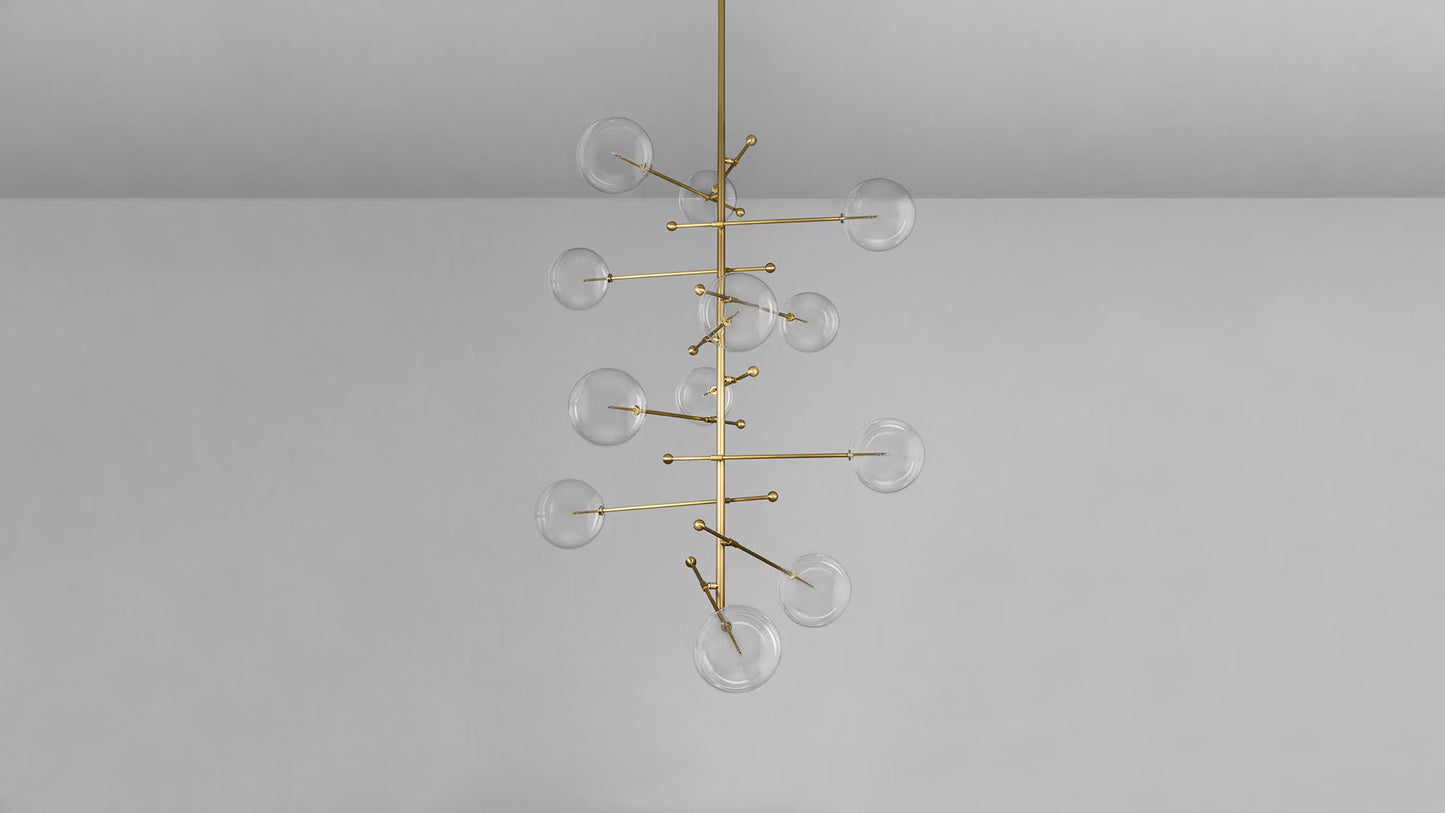 Transparent glass globe chandelier with brass rod frame.