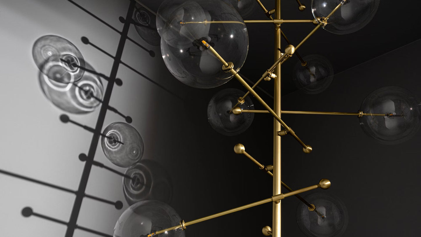 Modern chandelier casting dramatic shadows on a dark wall.
