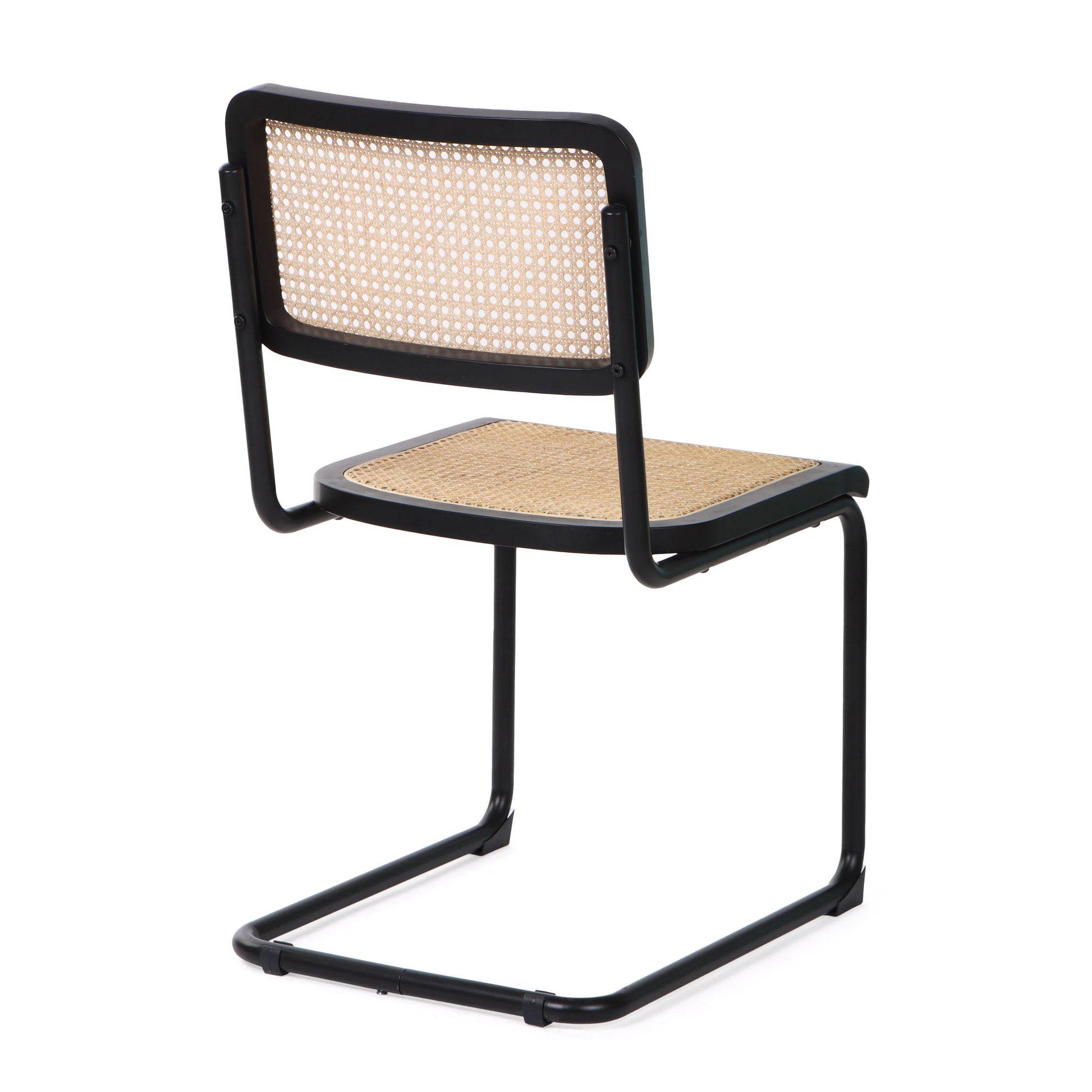 Back view of a black cane dining chair highlighting its rattan backrest and smooth black steel frame.