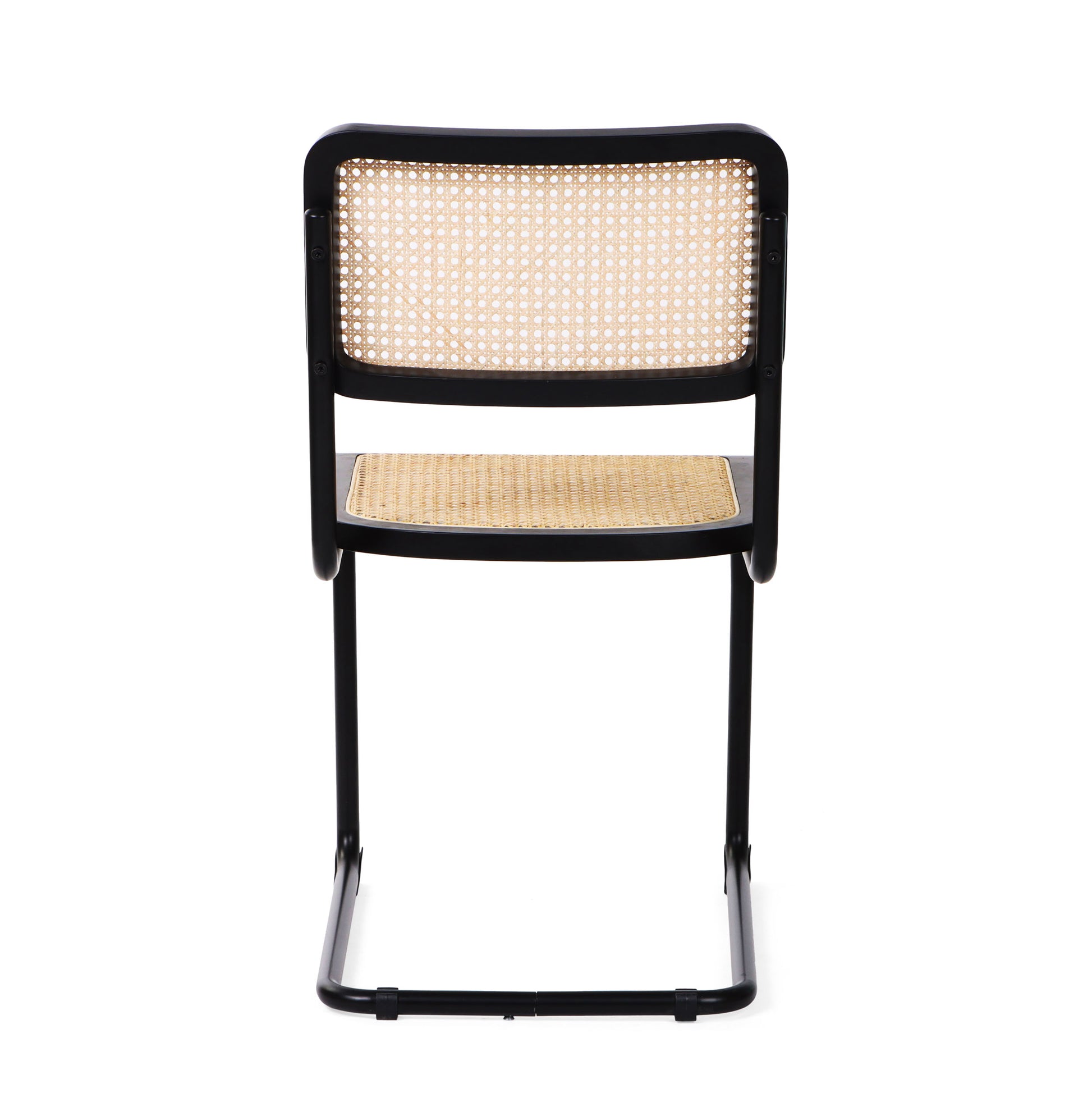 Rear view of a black cane dining chair showcasing the elegant curves of its tubular steel frame.