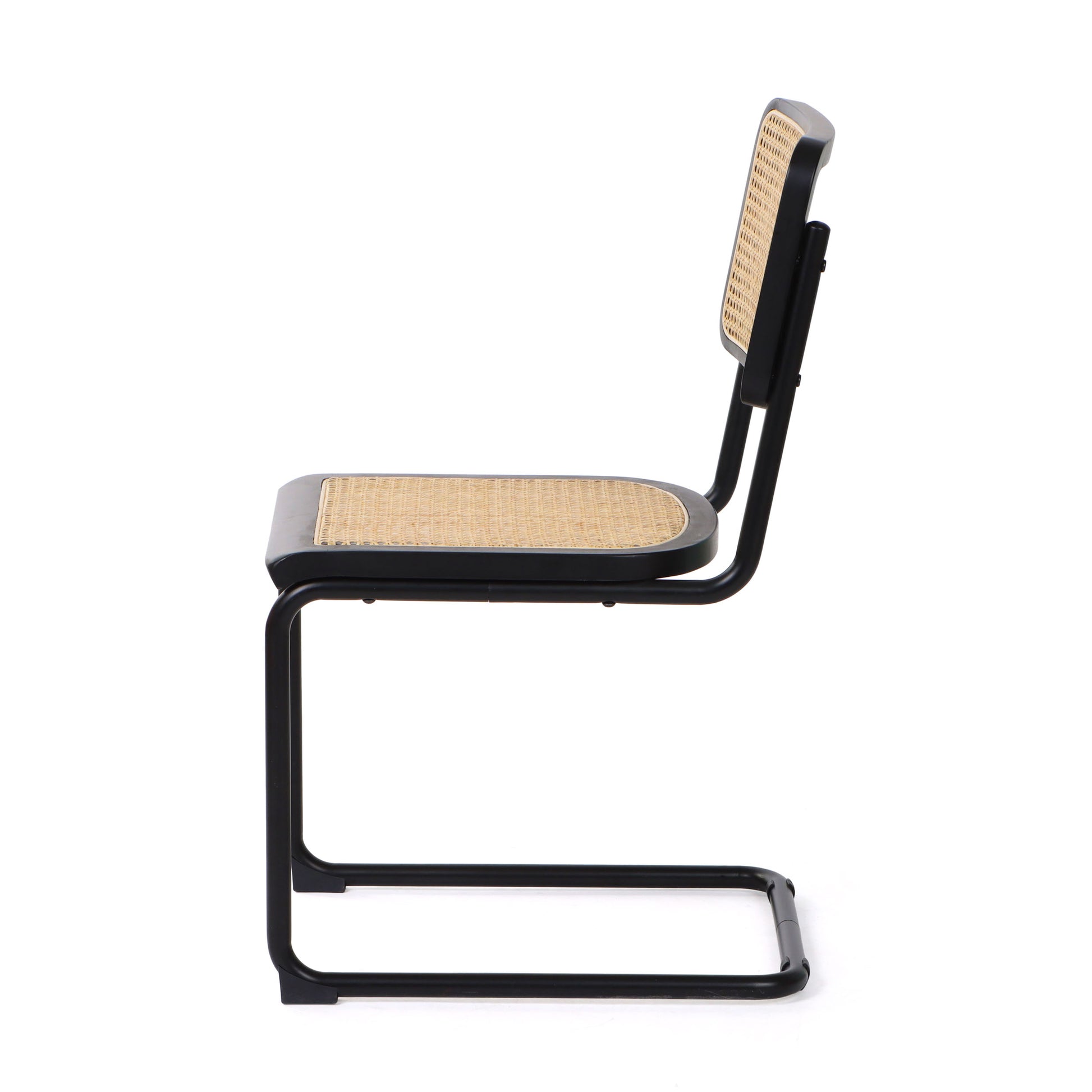 Side view of a black cane dining chair displaying its cantilever design and sleek black finish.