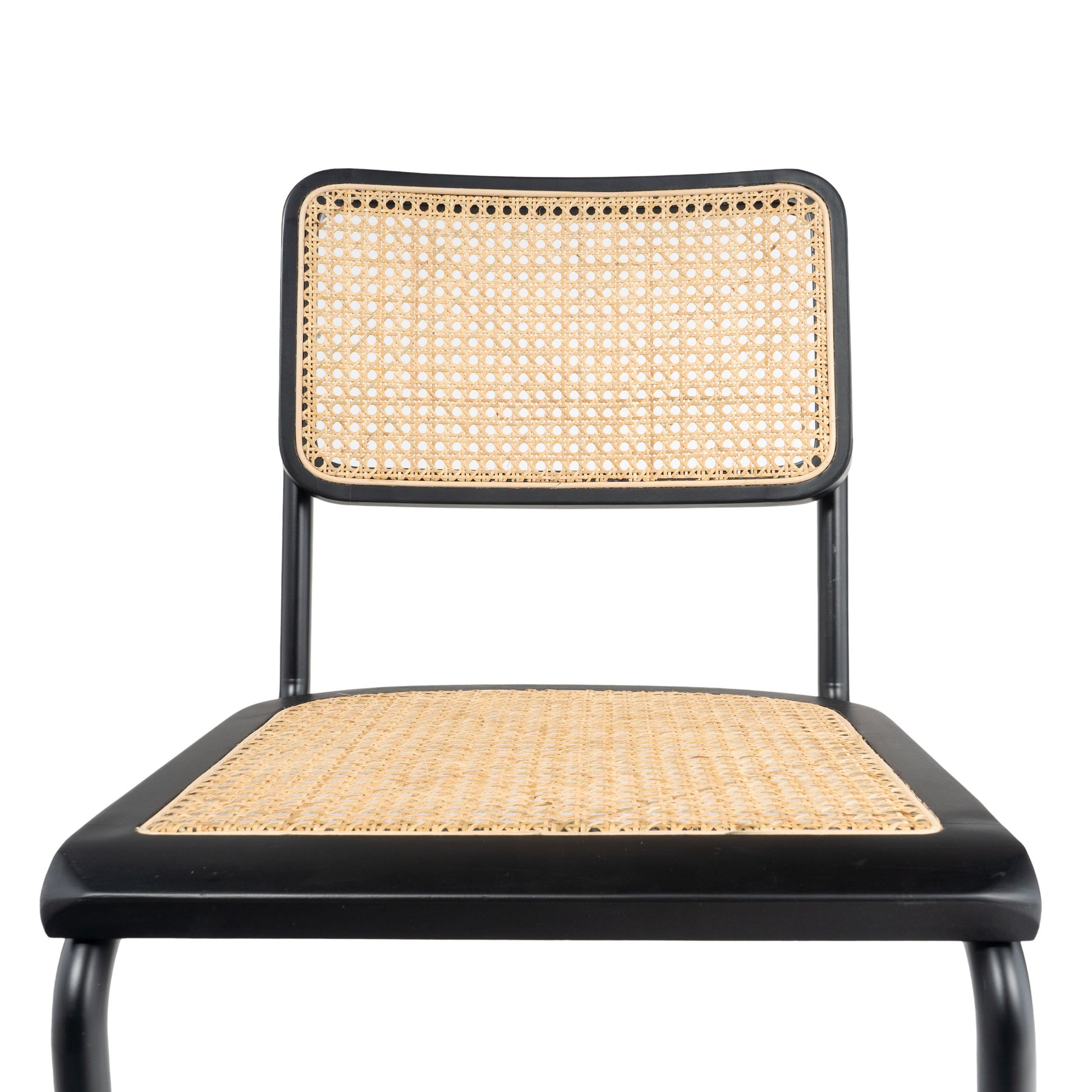 Close-up of the woven rattan backrest on a black cane dining chair, emphasizing craftsmanship and texture.