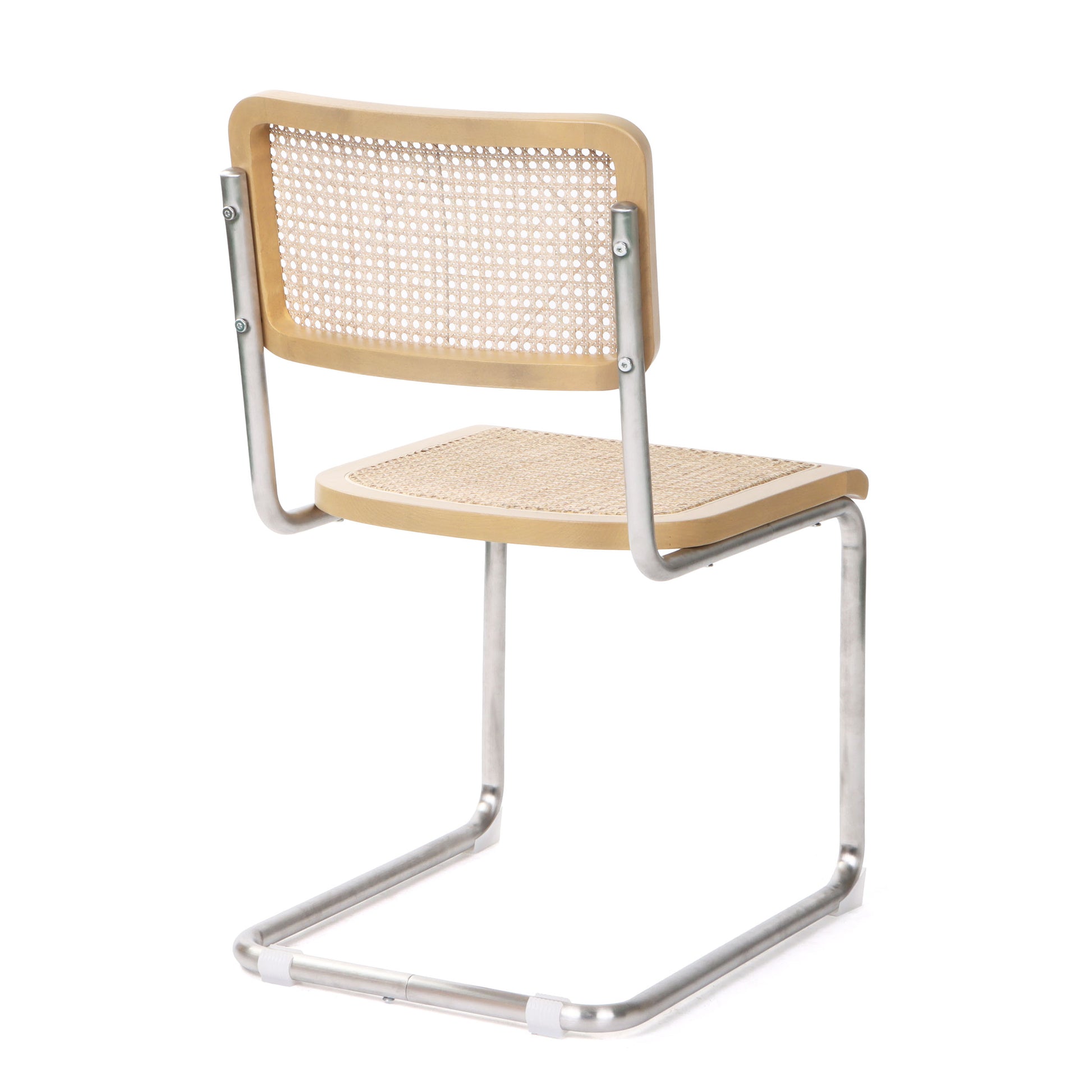 Back view of silver cane dining chair with a sleek stainless steel frame and cantilevered design.