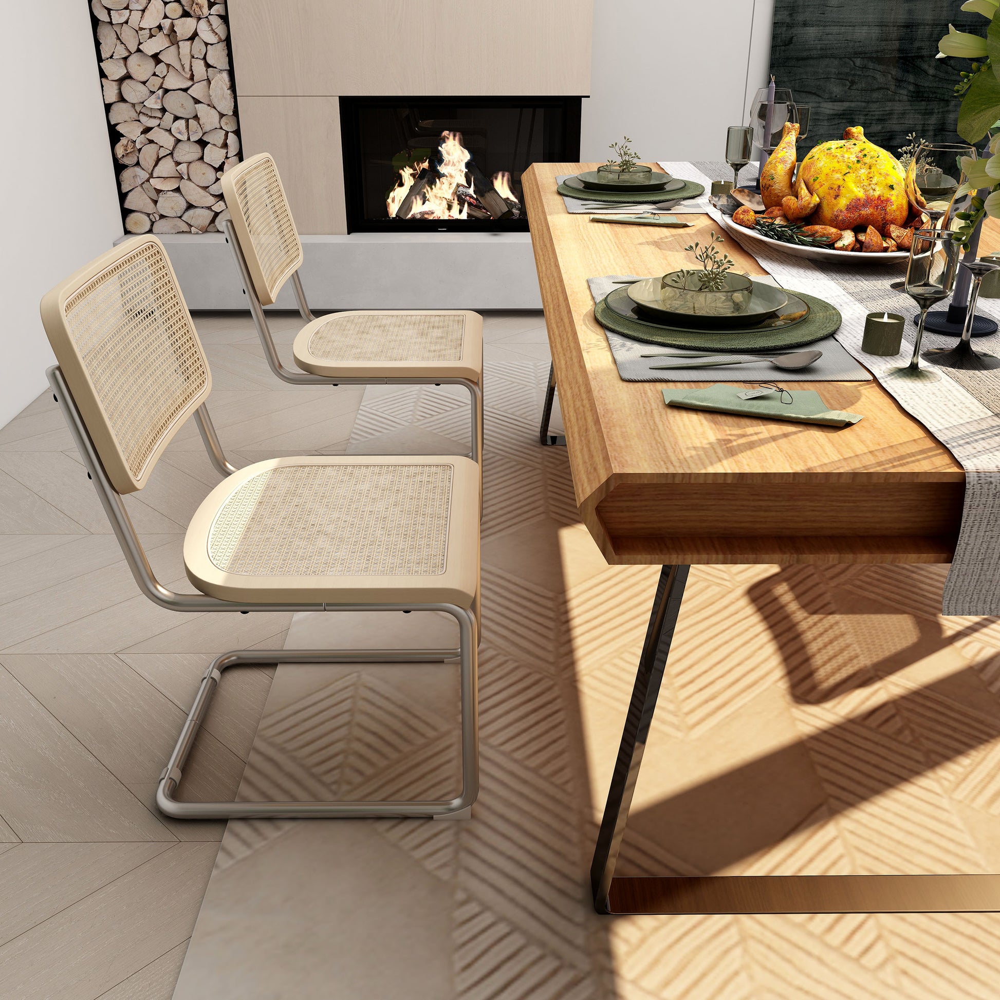 Two silver cane dining chairs with steel frames beside a dining table near a cozy fireplace.