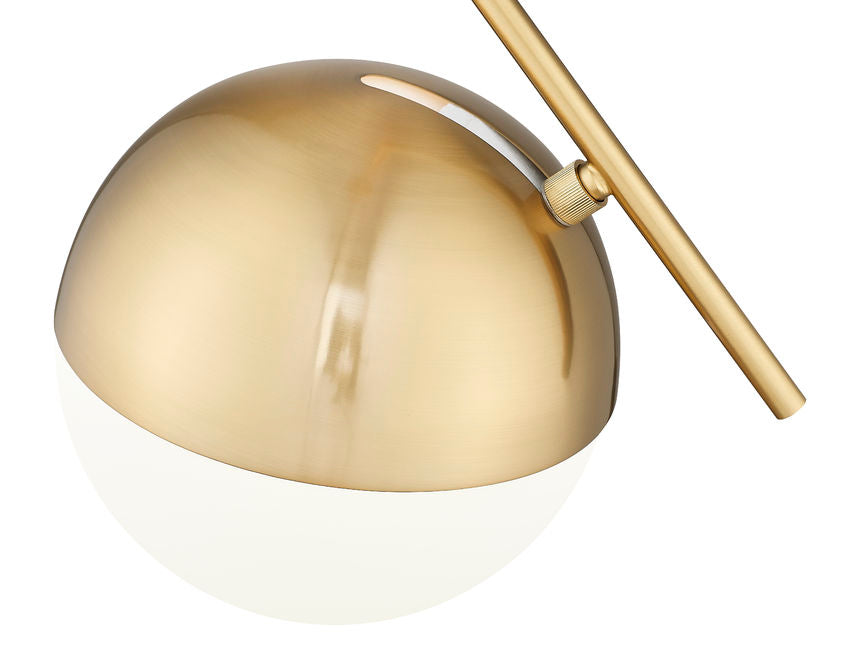 Close-up of brushed gold pendant light showing opal glass globe and metallic finish.