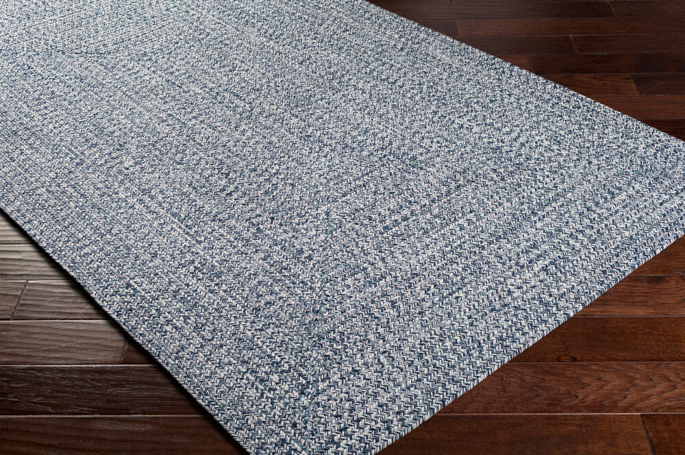 Rectangular Chesapeake Bay Denim Rug in soft blue tones on a hardwood floor