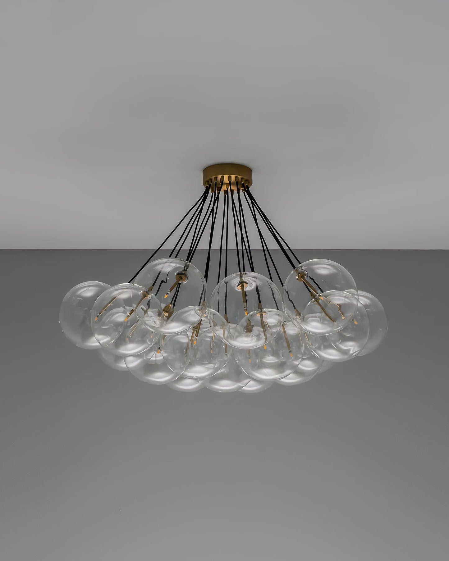 Cloud chandelier with lights off, showcasing brass detailing and sleek black lines.