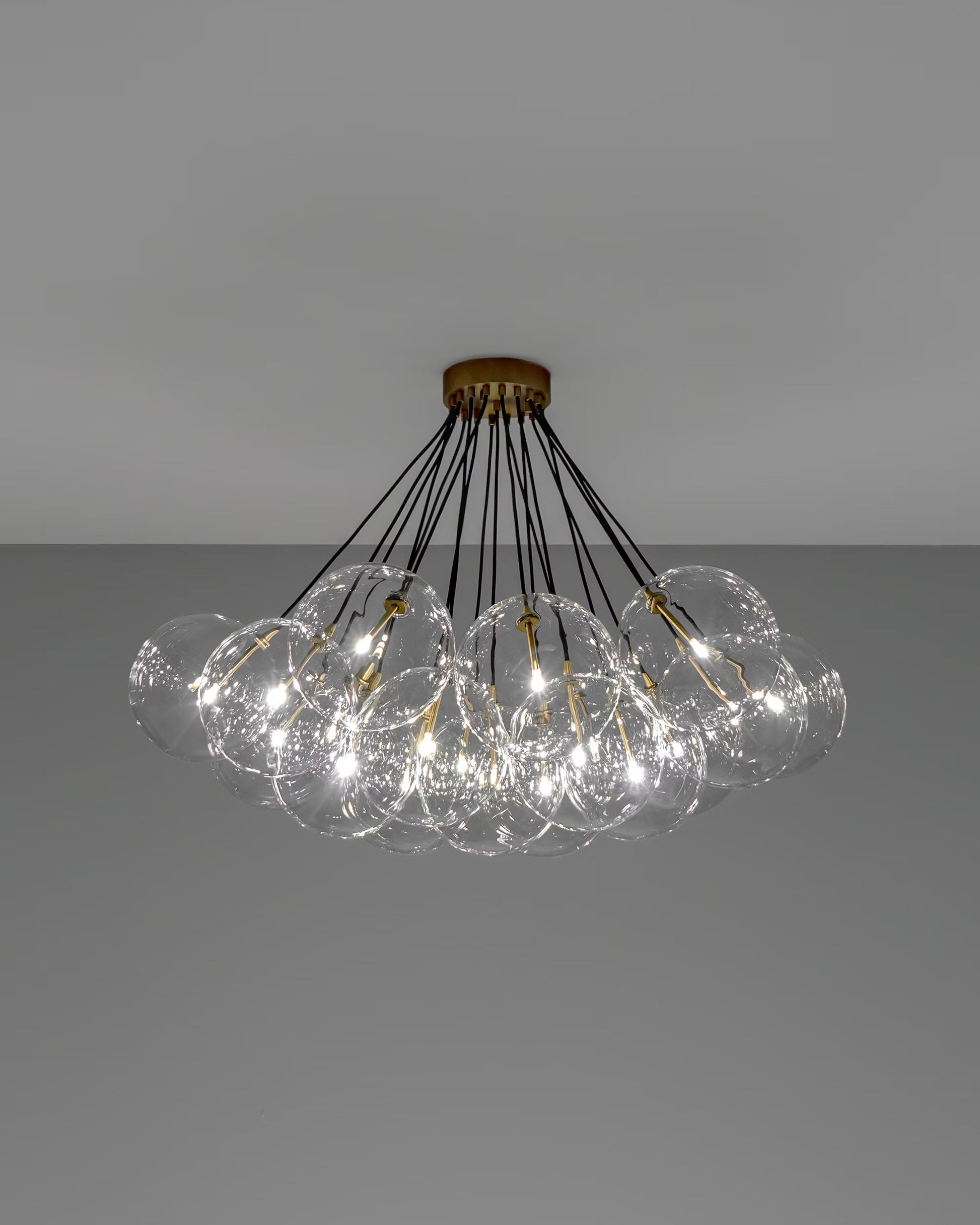 Cloud chandelier illuminated, highlighting its glowing, soap-bubble-like globes.