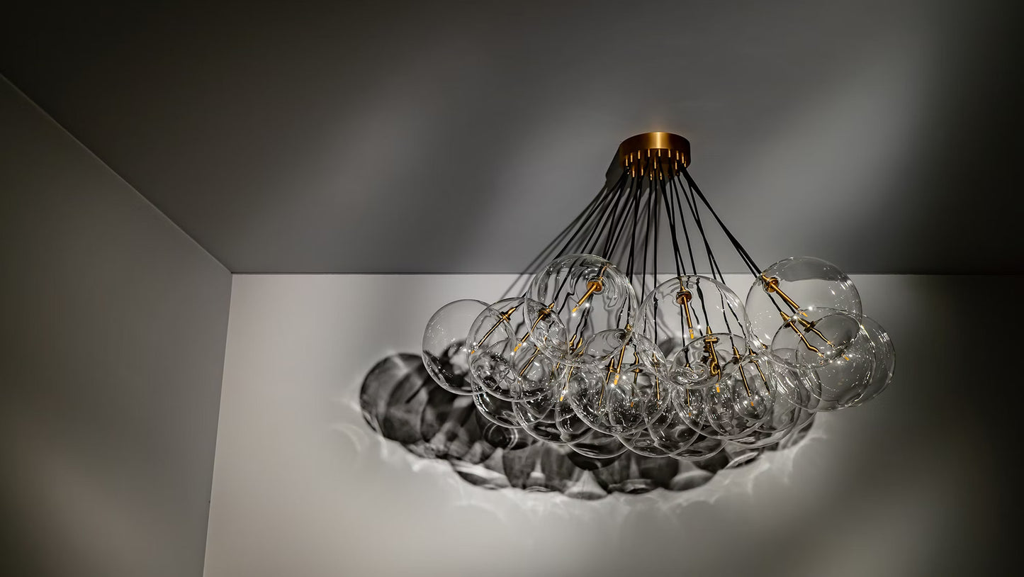 Cluster chandelier with brass canopy and suspended glass globes