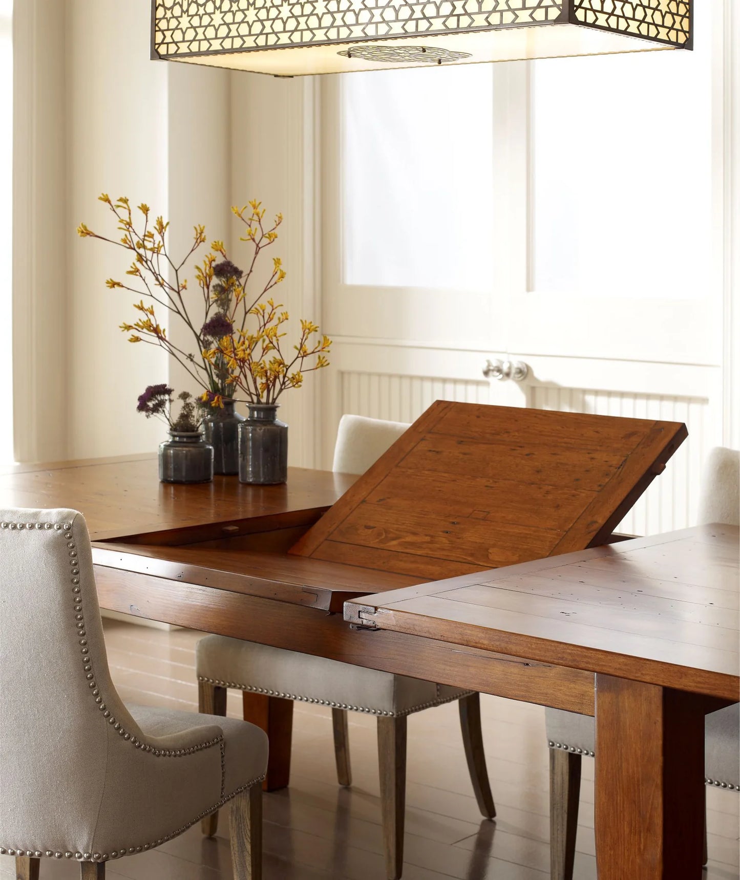 Close-up view of butterfly extension mechanism on the Irish Coast Rustic Extension Dining Table.