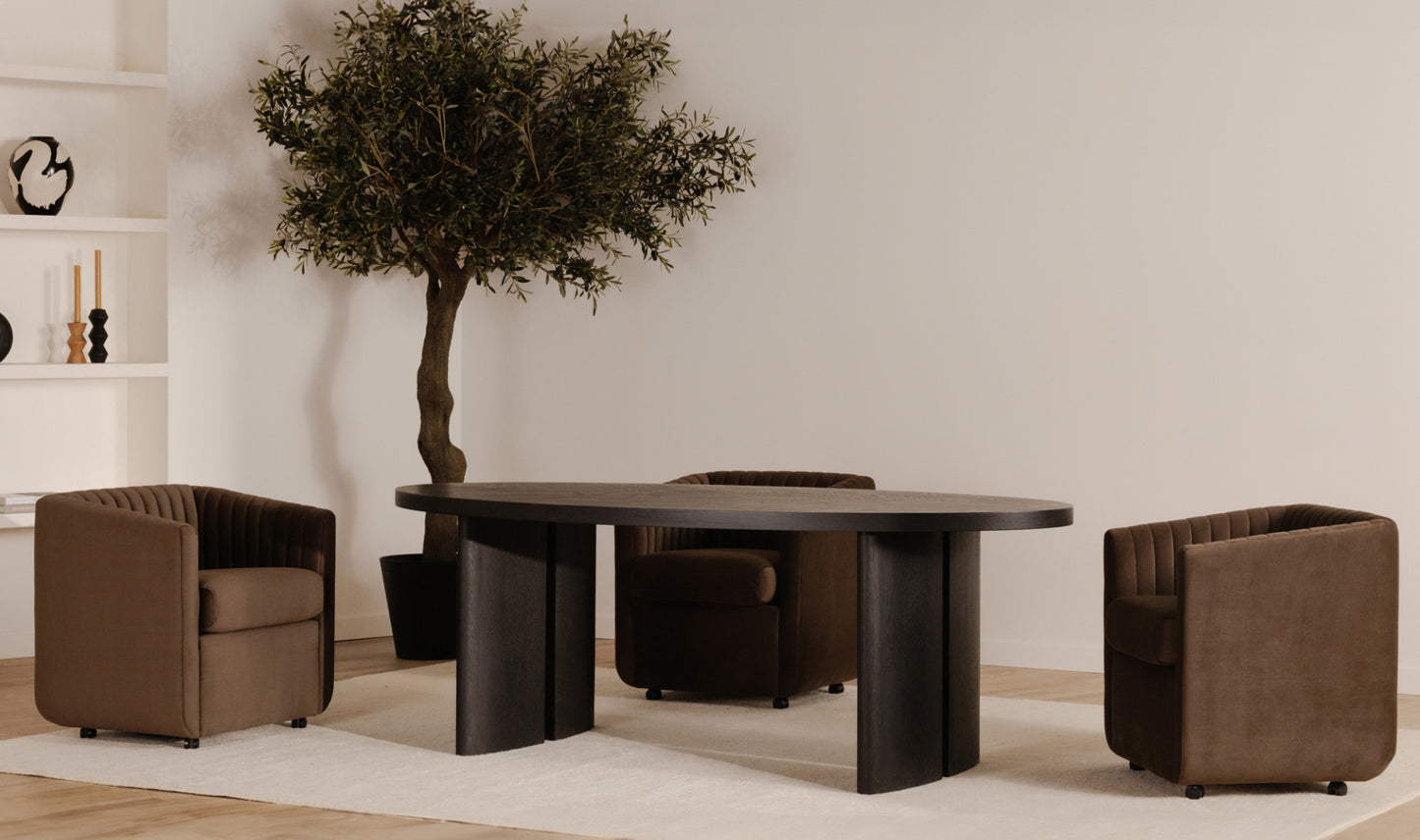 The Jane brown velvet dining chair styled in a modern dining room, adding contemporary elegance.