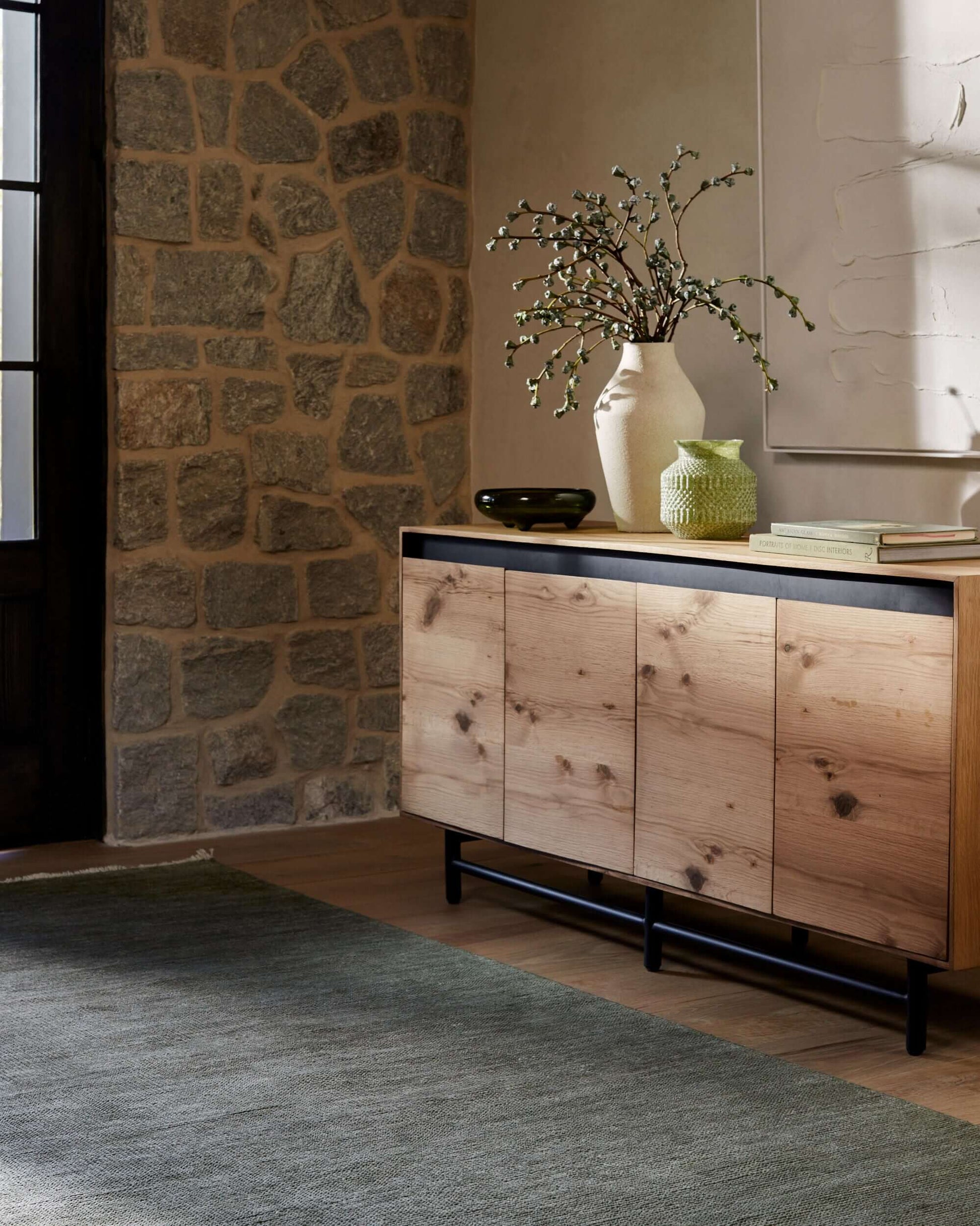 Molander Dining Sideboard in a rustic stone wall setting, blending modern design with natural elements.