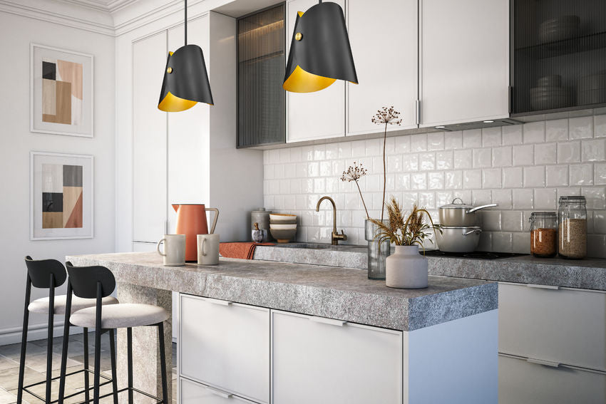 Modern one-light pendant pair above marble kitchen island.