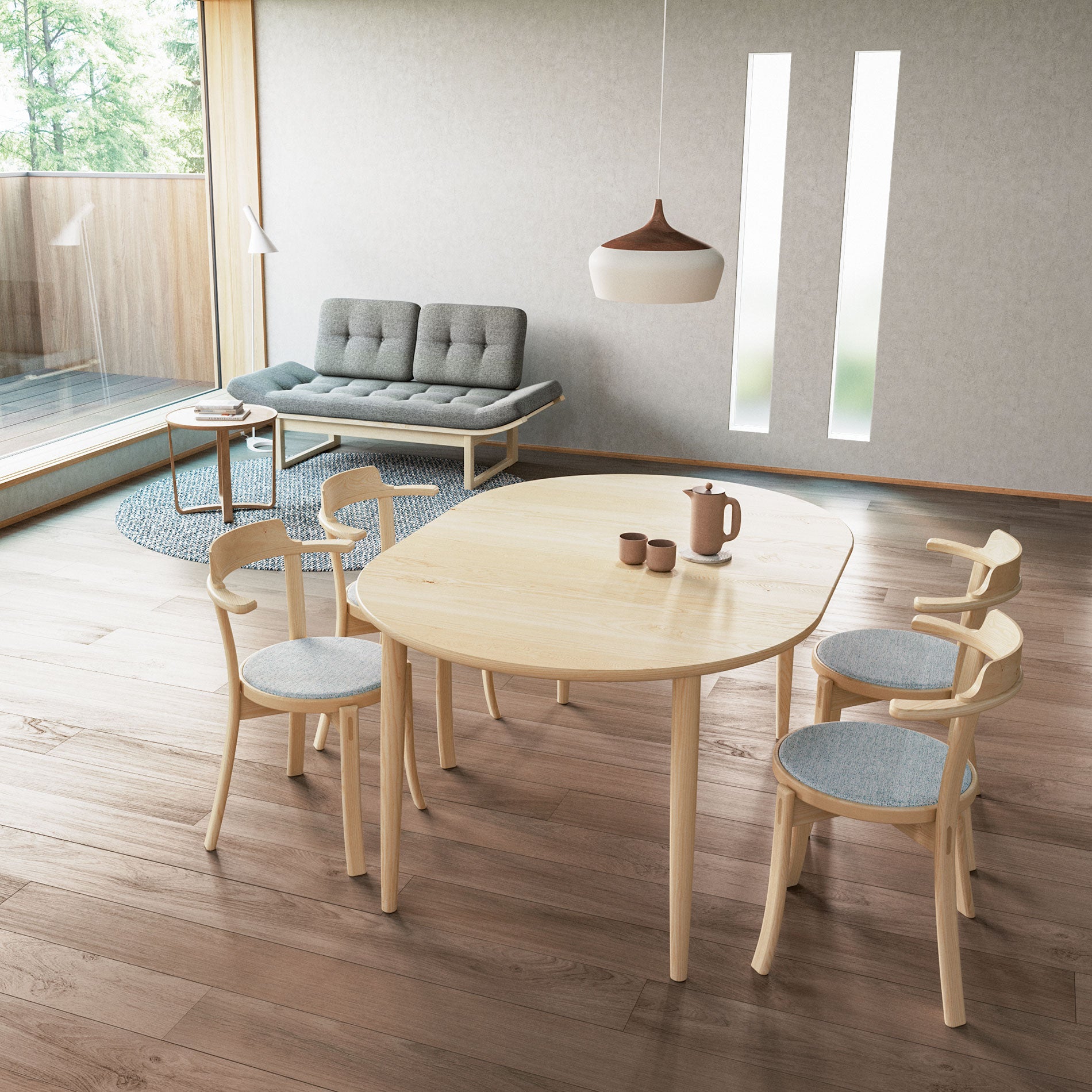 Japandi-style dining table with light wood finish, set with matching chairs in a cozy interior.