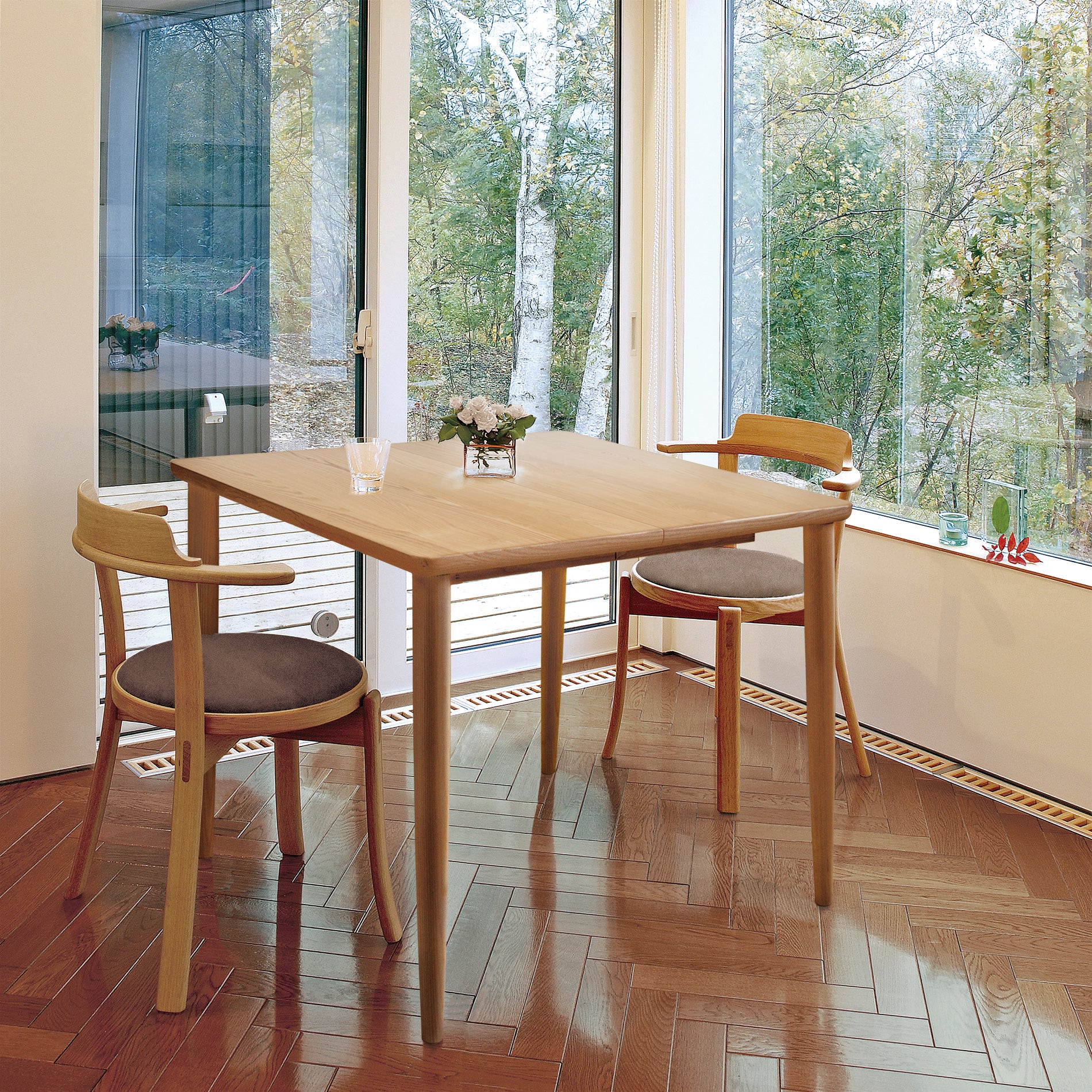 Square extension dining table set in a cozy dining space with natural light and wooden chairs.