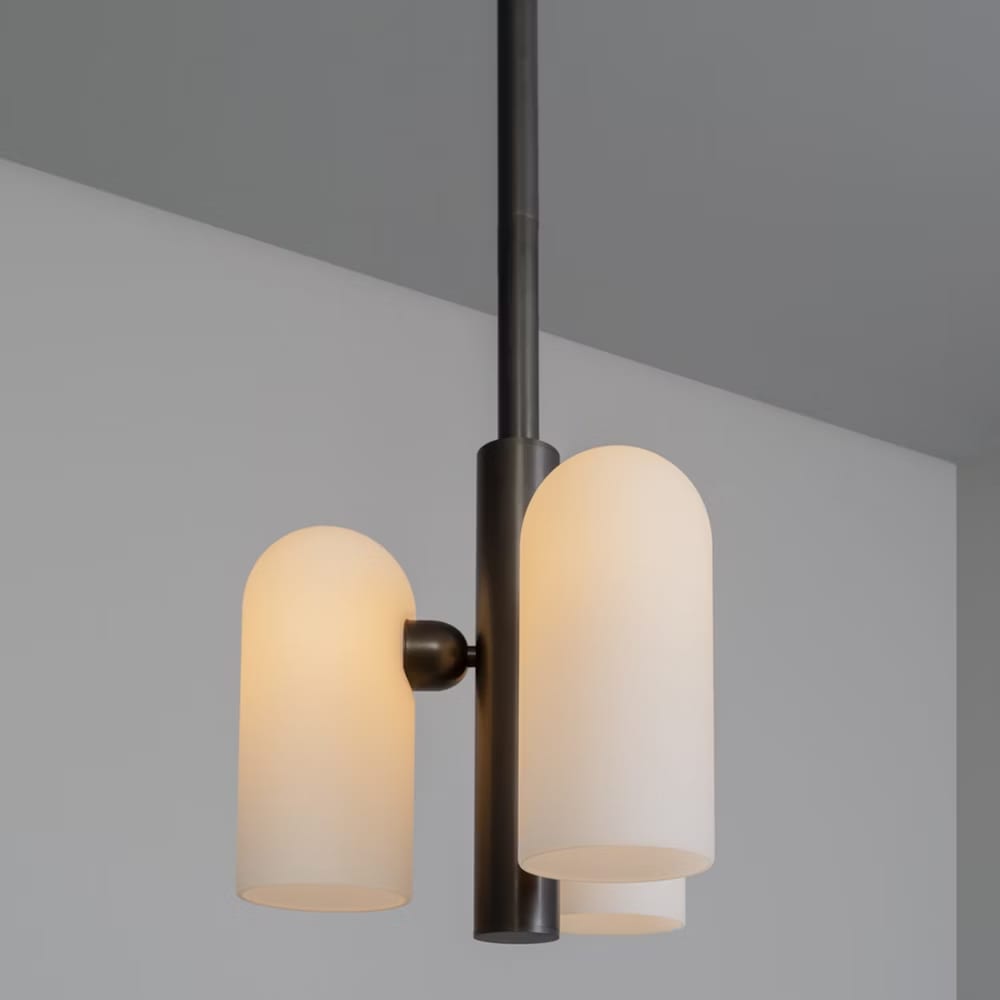 Close-up of the lit Odyssey 3 Pendant's frosted glass and black finish.