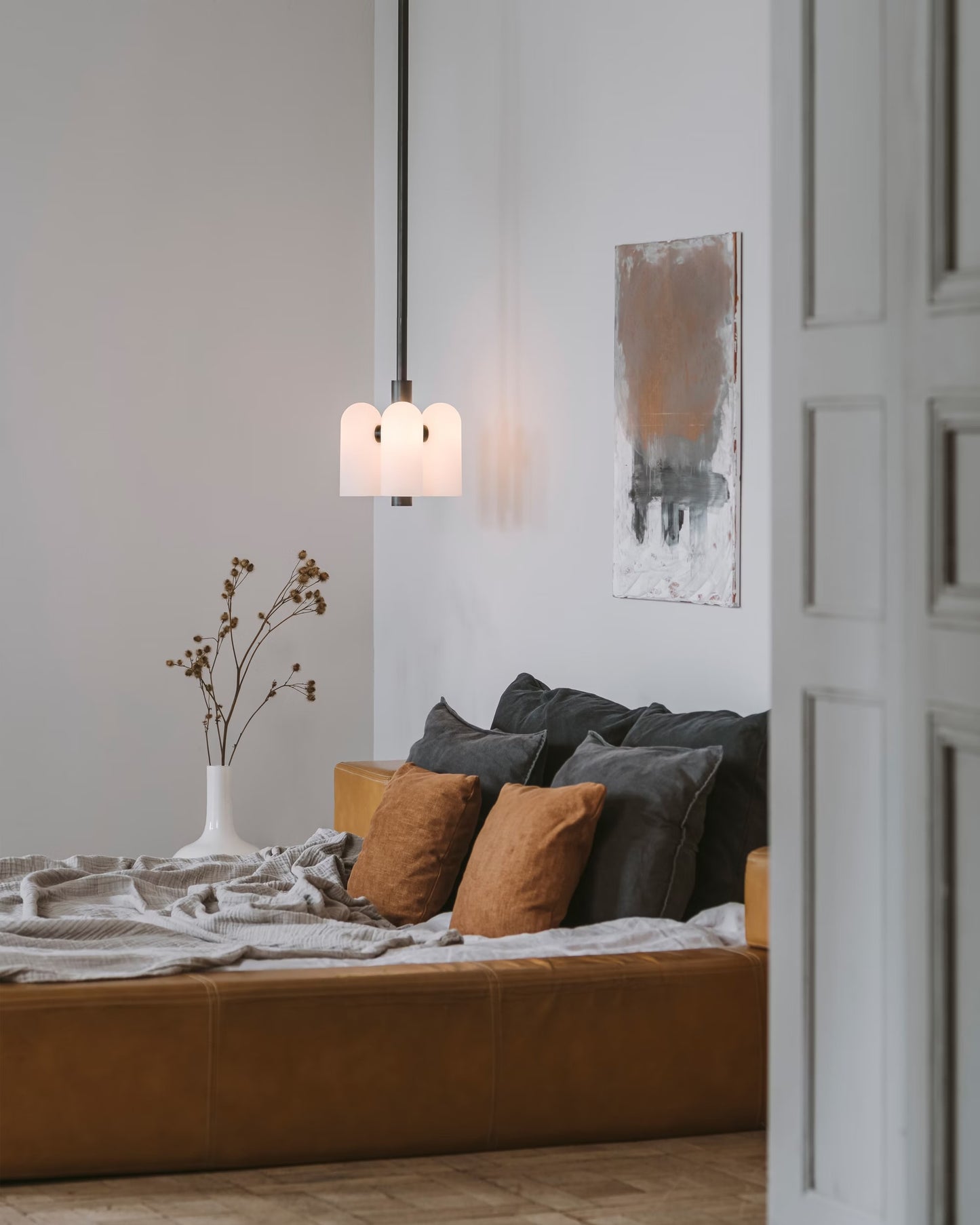 Odyssey 4 Pendant light in a modern bedroom with minimalist décor and natural tones.
