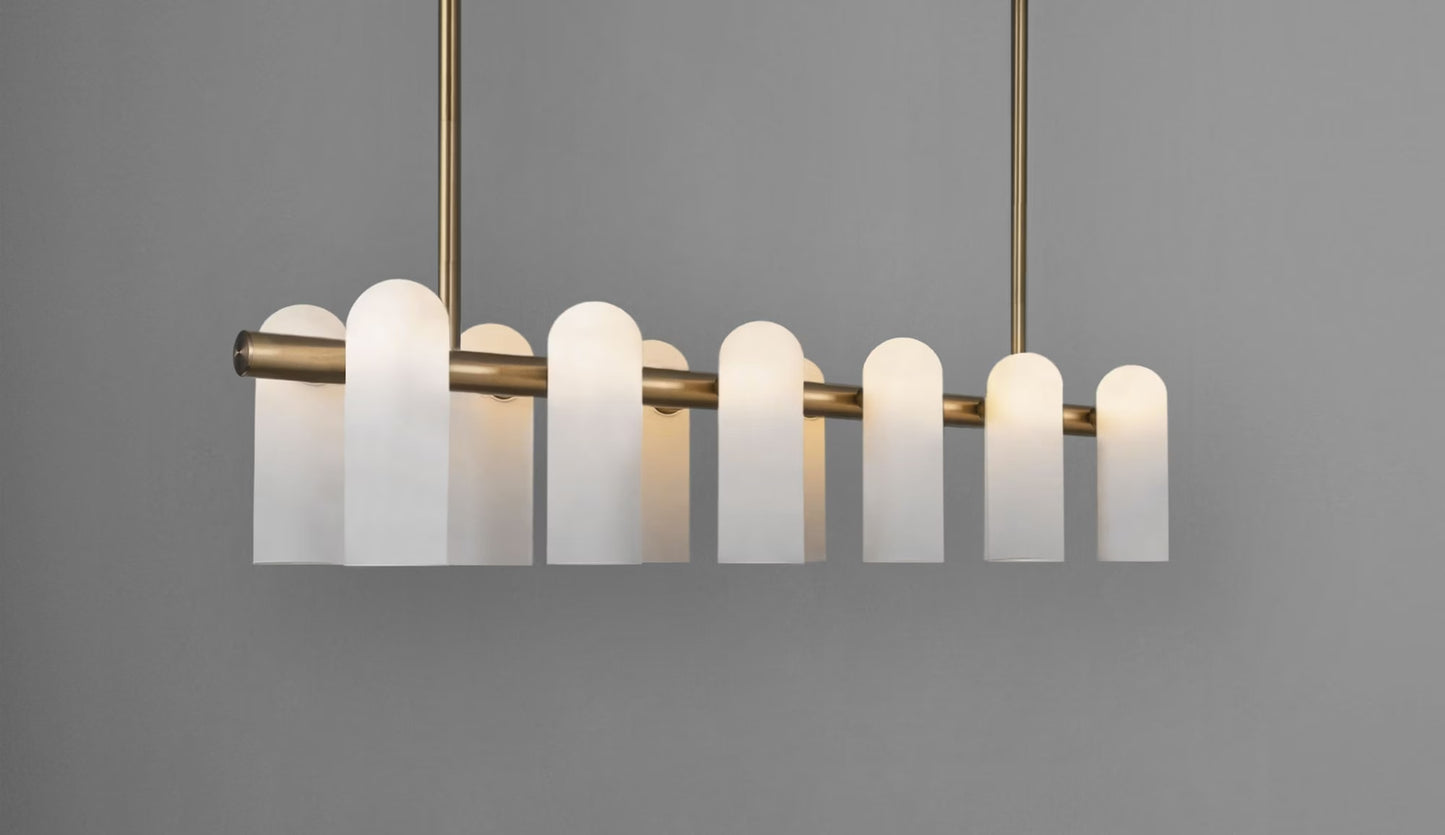 Illuminated brass chandelier with frosted glass shades, creating a warm and inviting ambiance.