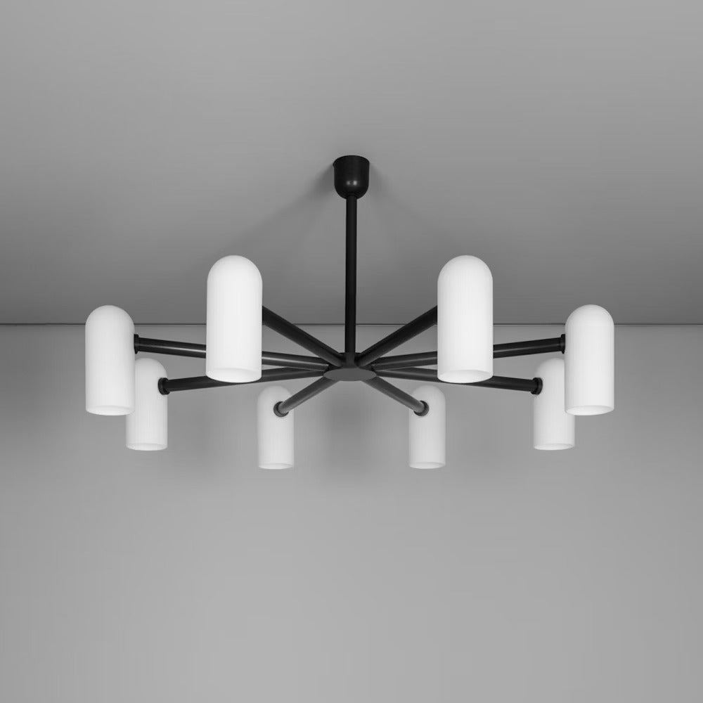 Black gunmetal chandelier with frosted glass shades, mounted on the ceiling for a modern aesthetic.