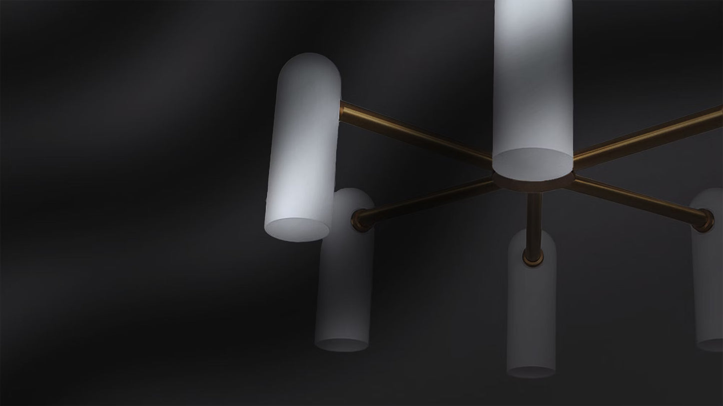 Close-up of a brass chandelier with frosted opal glass shades against a dark background.