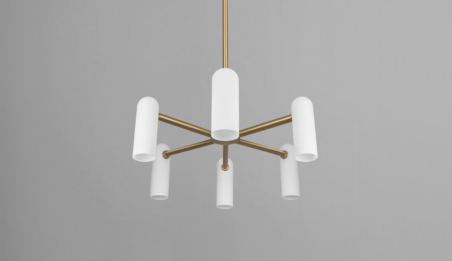 Brass chandelier with cylindrical white opal glass shades, suspended against a neutral background.