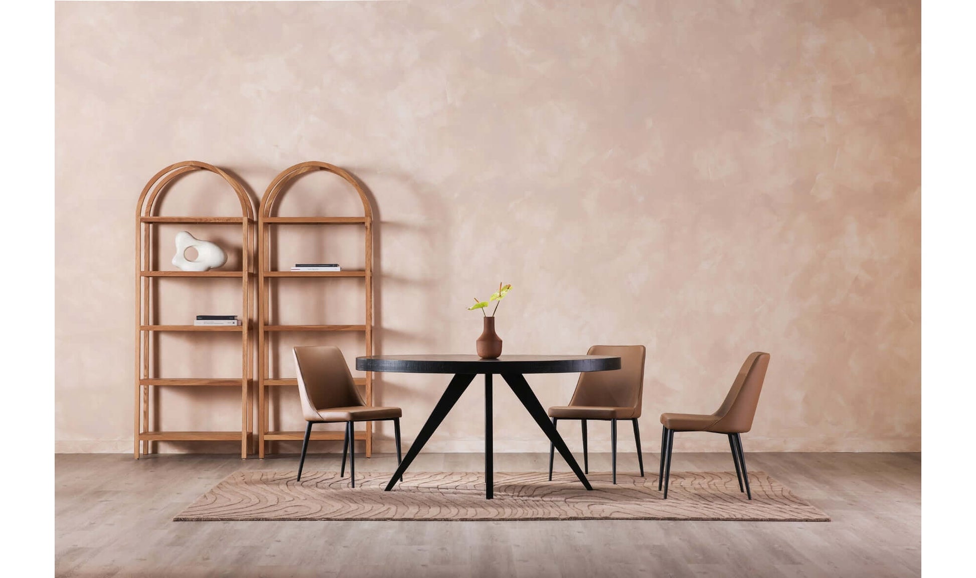 Parq Black Oval Dining Table styled in a modern dining room setting with neutral decor.