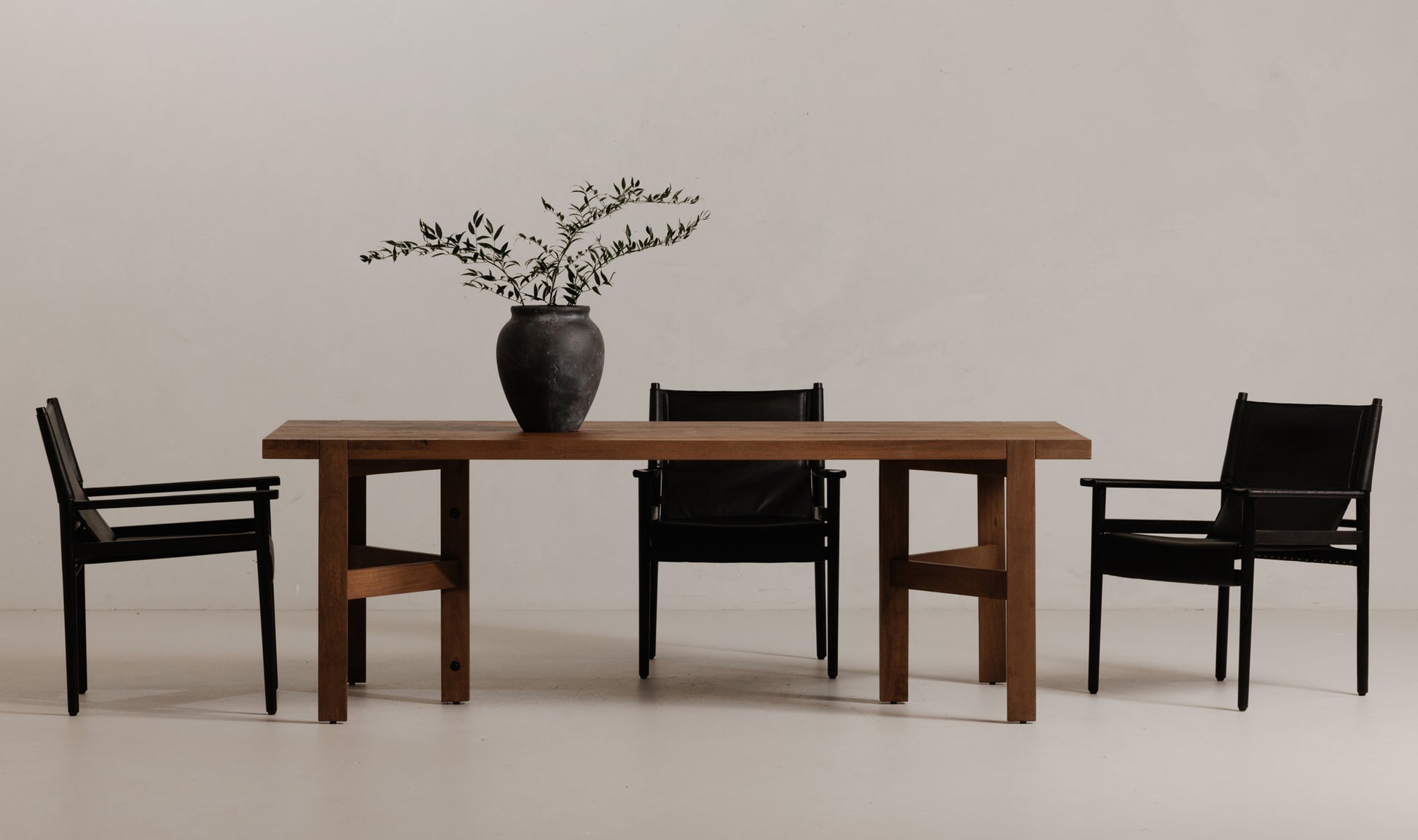 Remy Black Mid-Century Modern Dining Chairs set around a wooden dining table, adding a sophisticated touch to a modern dining room.