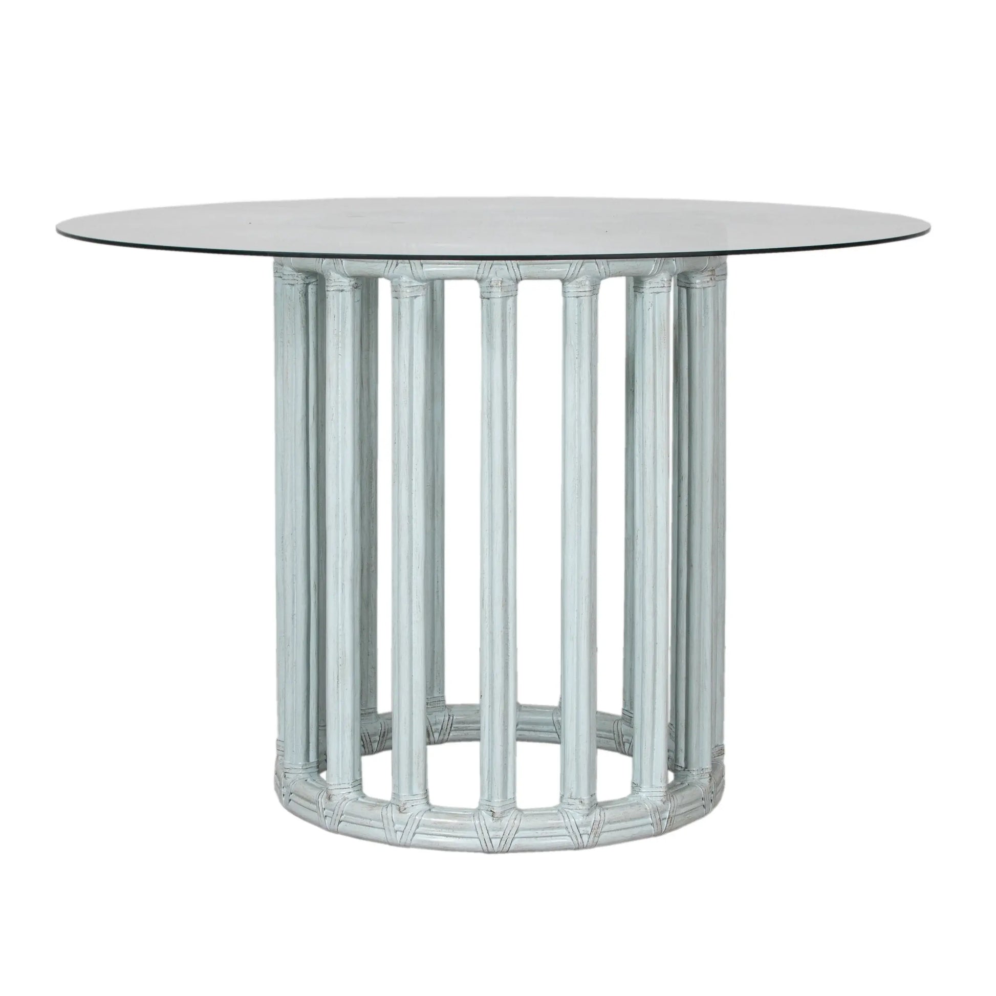Front view of a cloud blue round metal table base with rattan and glass top.