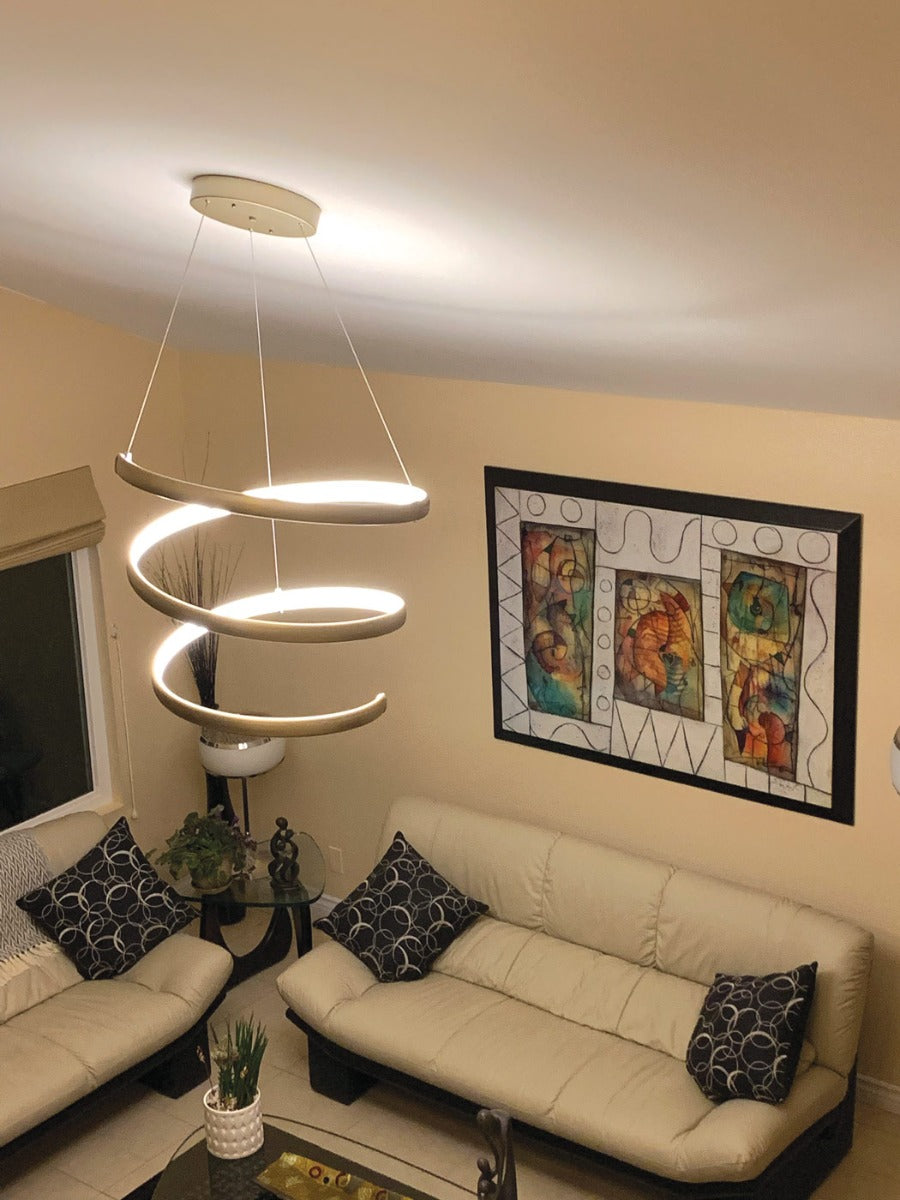Oval spring pendant light in titanium silver over beige living room.
