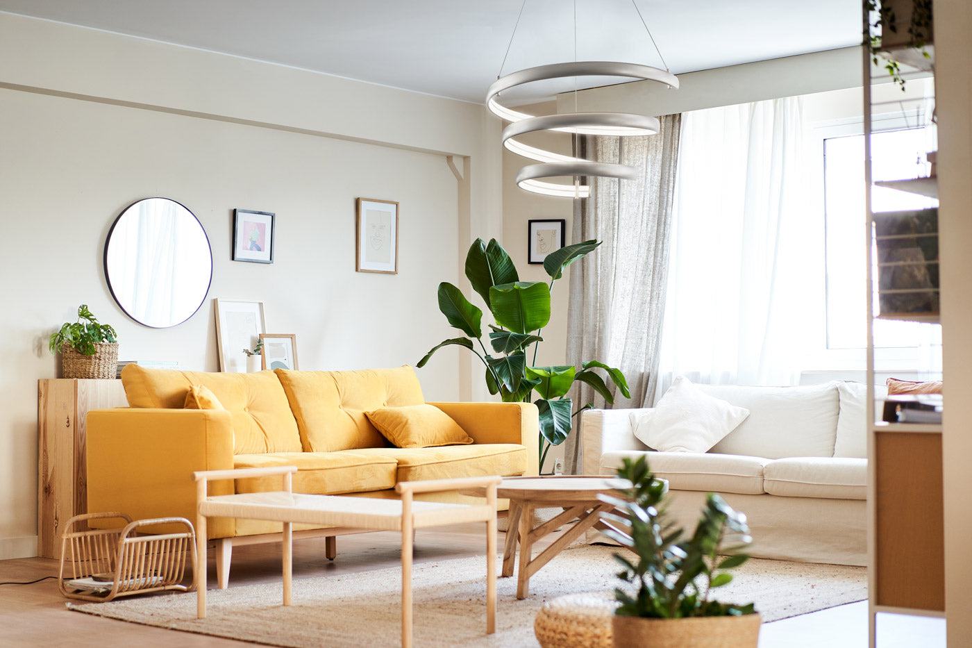 Oval spring pendant light titanium silver above modern living room with yellow sofa