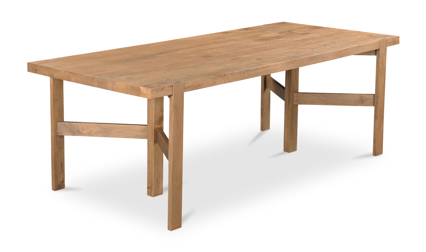 Side view of the Workshop modern wooden dining table made from mango wood, with a rustic brown finish.