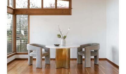 Graze Dining Table set in a modern dining room with minimalist decor and grey chairs.