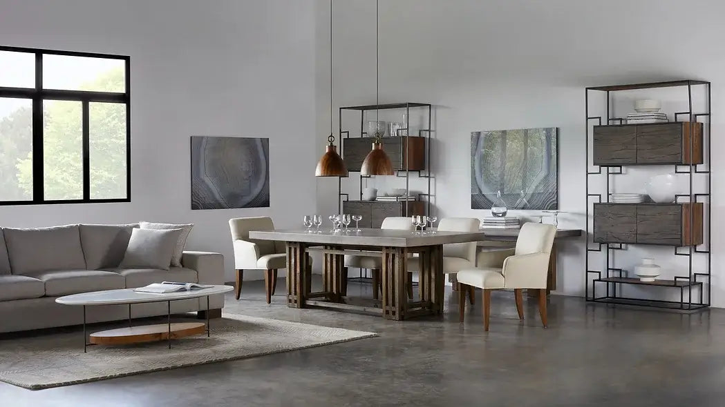 Room view of the Conrad Dining Table by Case & Canvas, highlighting its rustic brown finish and industrial concrete top.