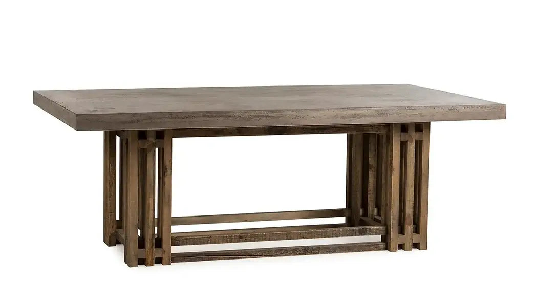 Angled view of the Conrad Dining Table by Case & Canvas with a natural concrete top and rustic brown finish.