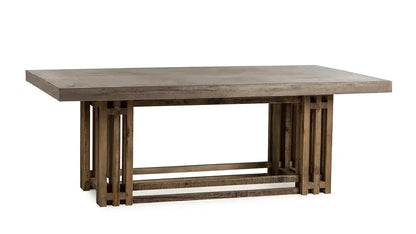 Angled view of the Conrad Dining Table by Case & Canvas with a natural concrete top and rustic brown finish.