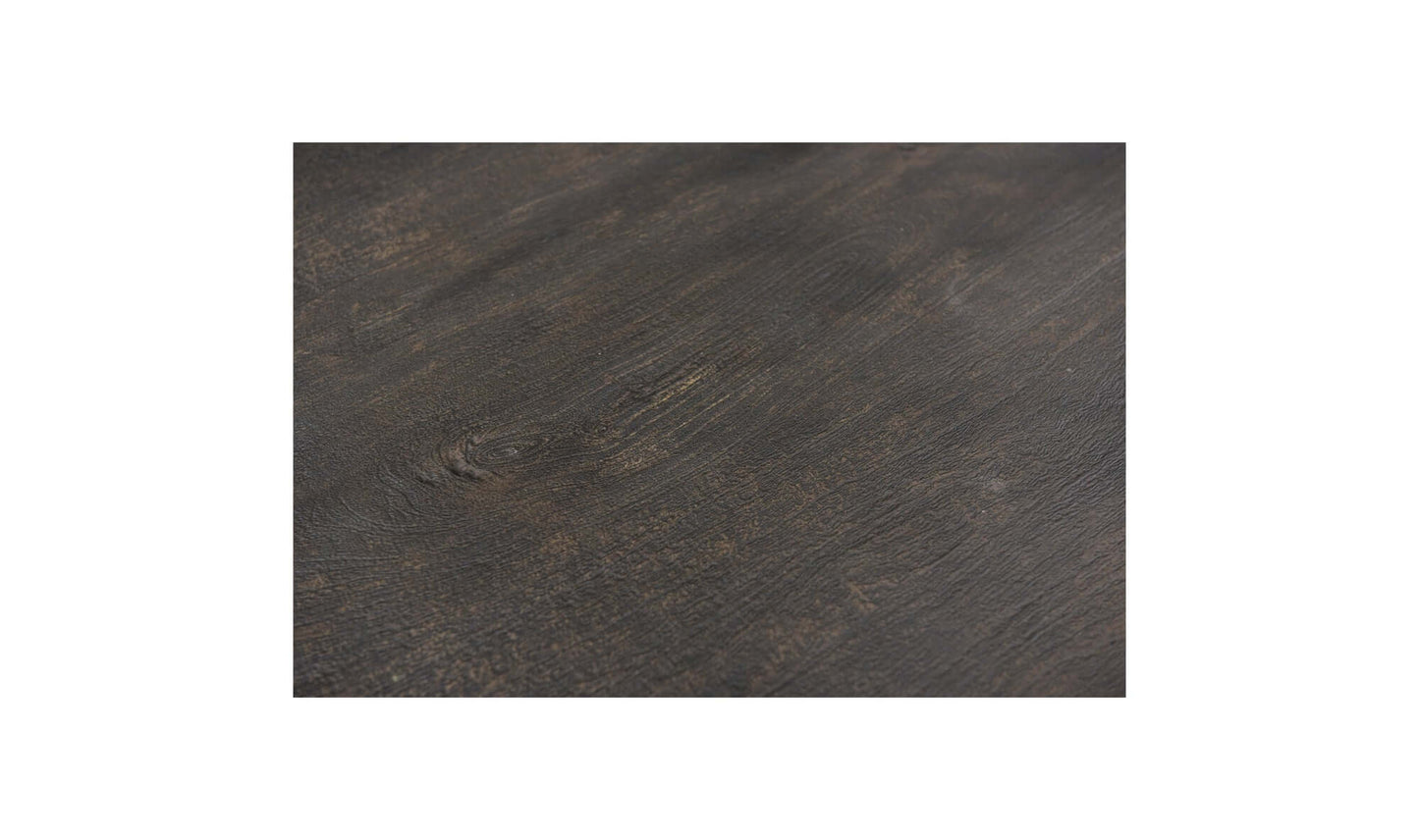  Detailed close-up of the Brolio Dining Table’s dark mango wood finish, emphasizing its rich texture.