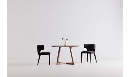 Godenza Round Brown Dining Table paired with black chairs in a modern dining room