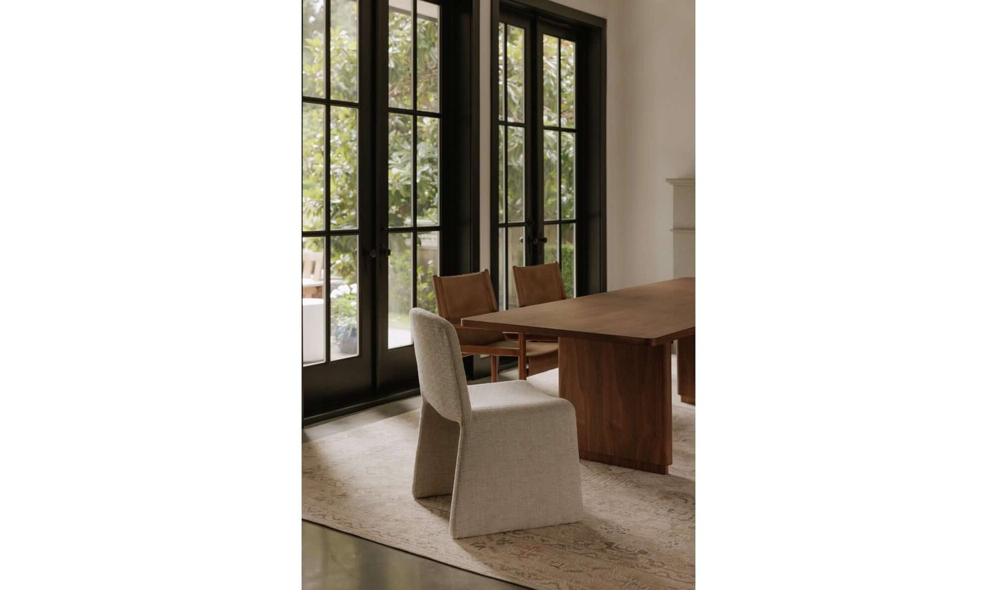 Ella Dining Chair in Heather Beige displayed in a modern dining room setting next to a wooden table.