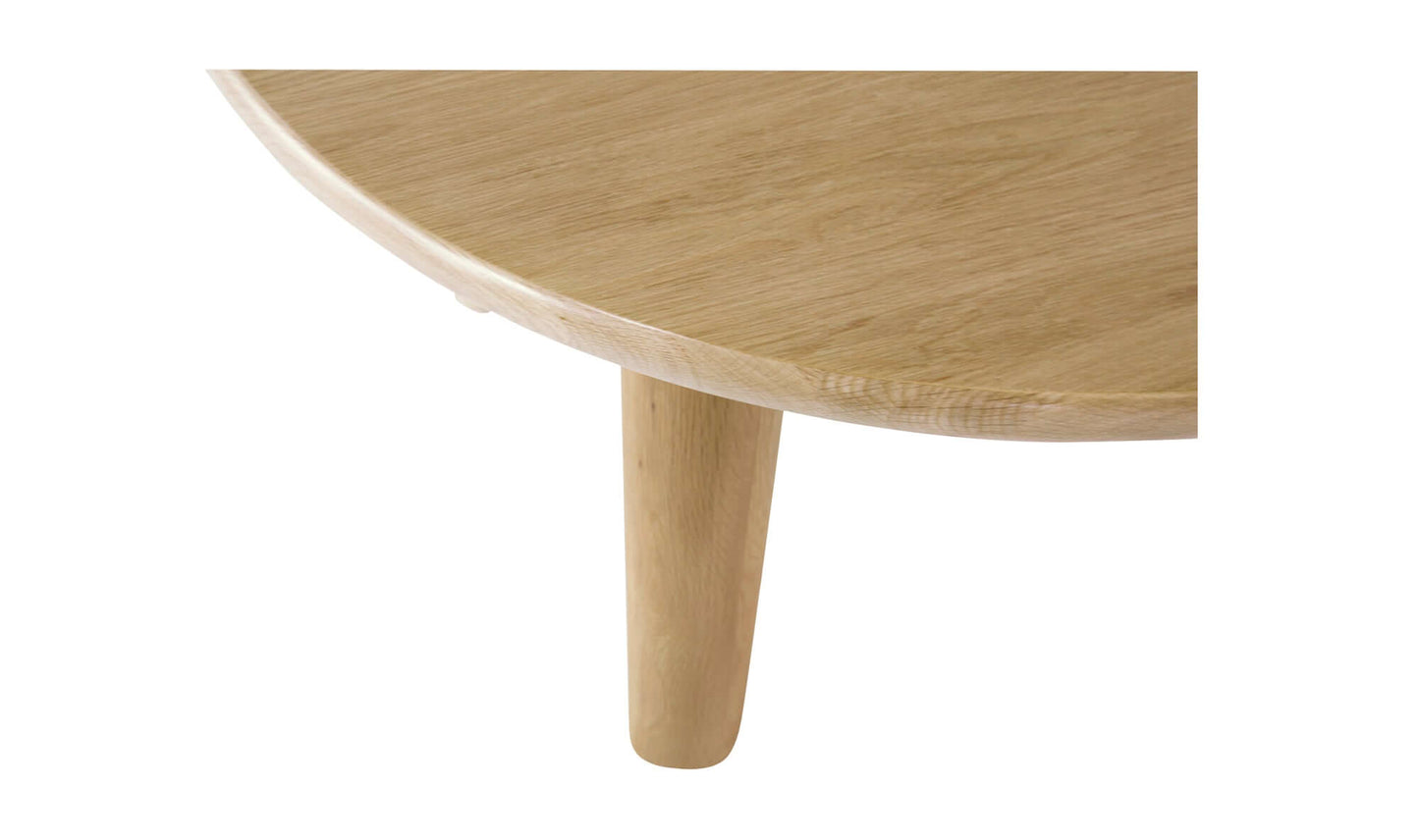 Close-up of the Milo Round Oak Dining Table's light oak finish and rounded edge.