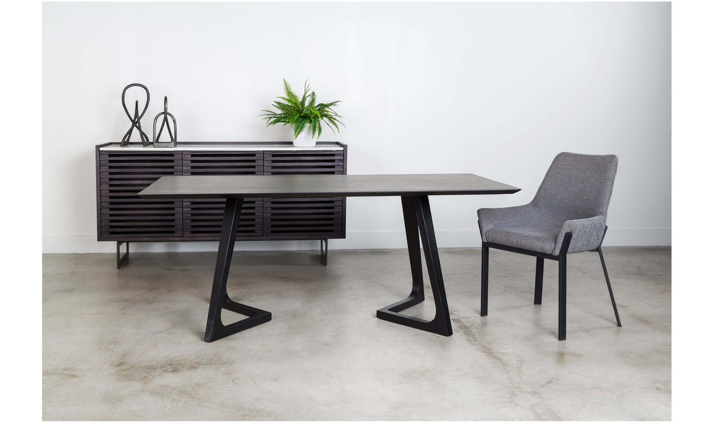 Godenza Black Rectangular Dining Table's base detail showing the blackened ash wood and artistic design.