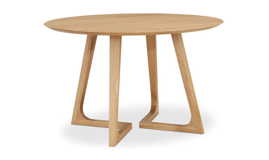 Side view of the Godenza Round Oak Dining Table, displaying its flared leg design and oak finish.