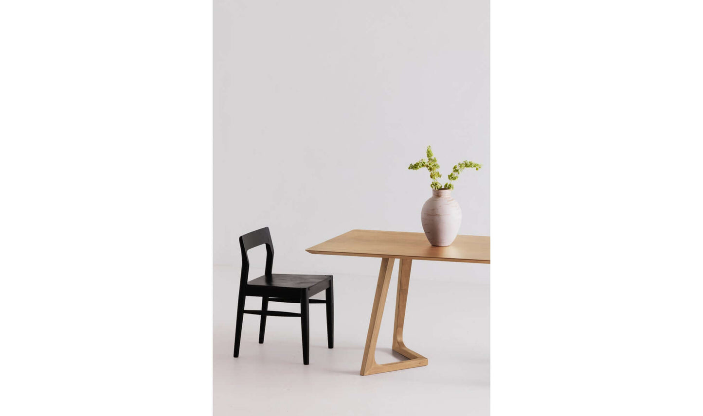 Godenza oak rectangular dining table set in a modern dining room with gray chair.