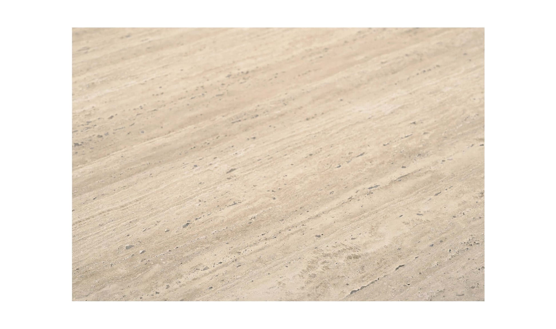 Detailed texture of the beige Italian travertine top of the Fia Dining Table.