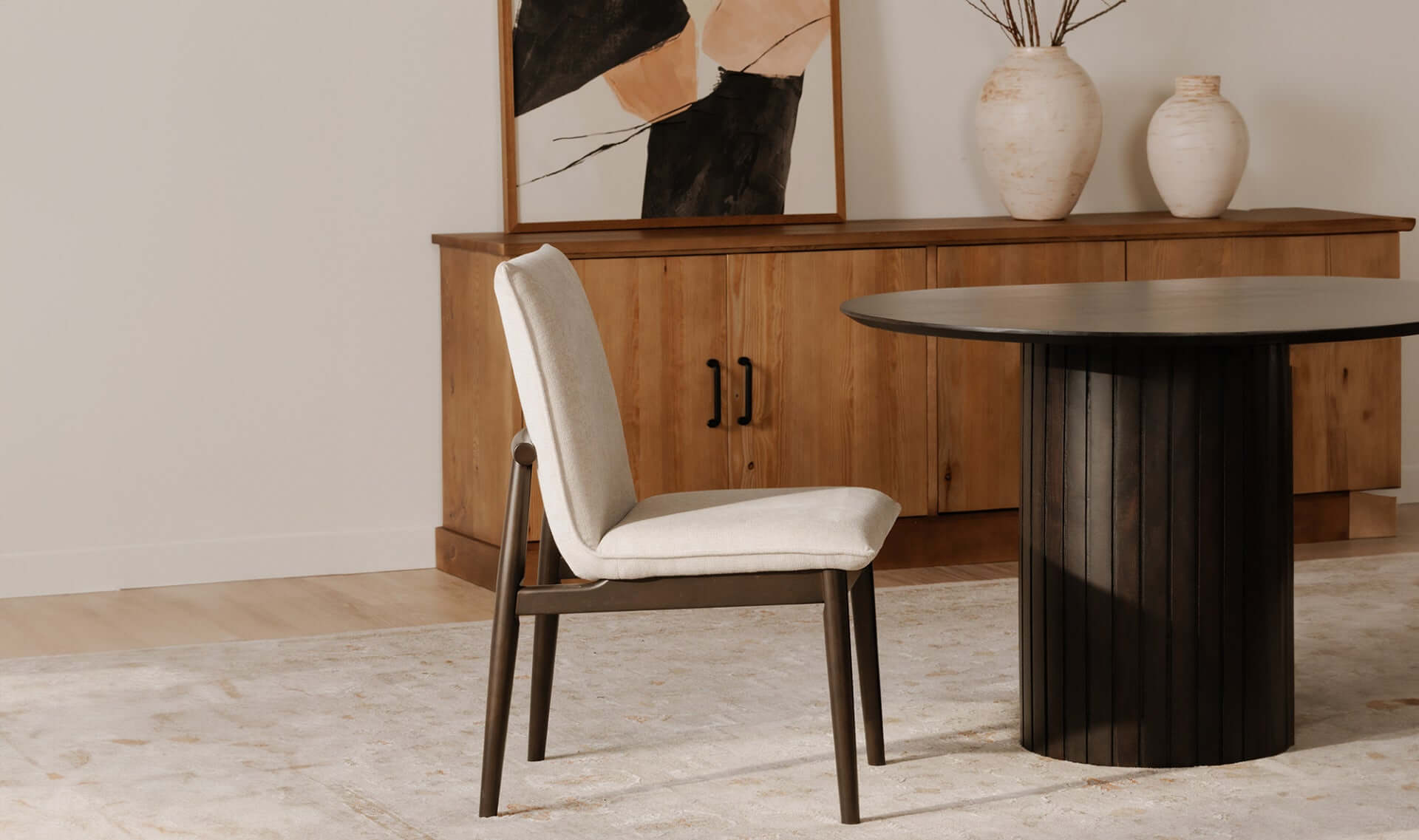 Side view of Charlie dining chair in a contemporary dining room with wooden furniture.