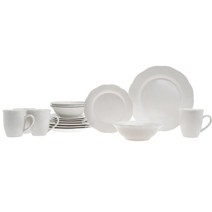 Side view of dinner ware set layed on a call white table.