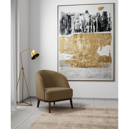 Abstract painting in a modern living room with beige chair, gold lamp, and light wood flooring.